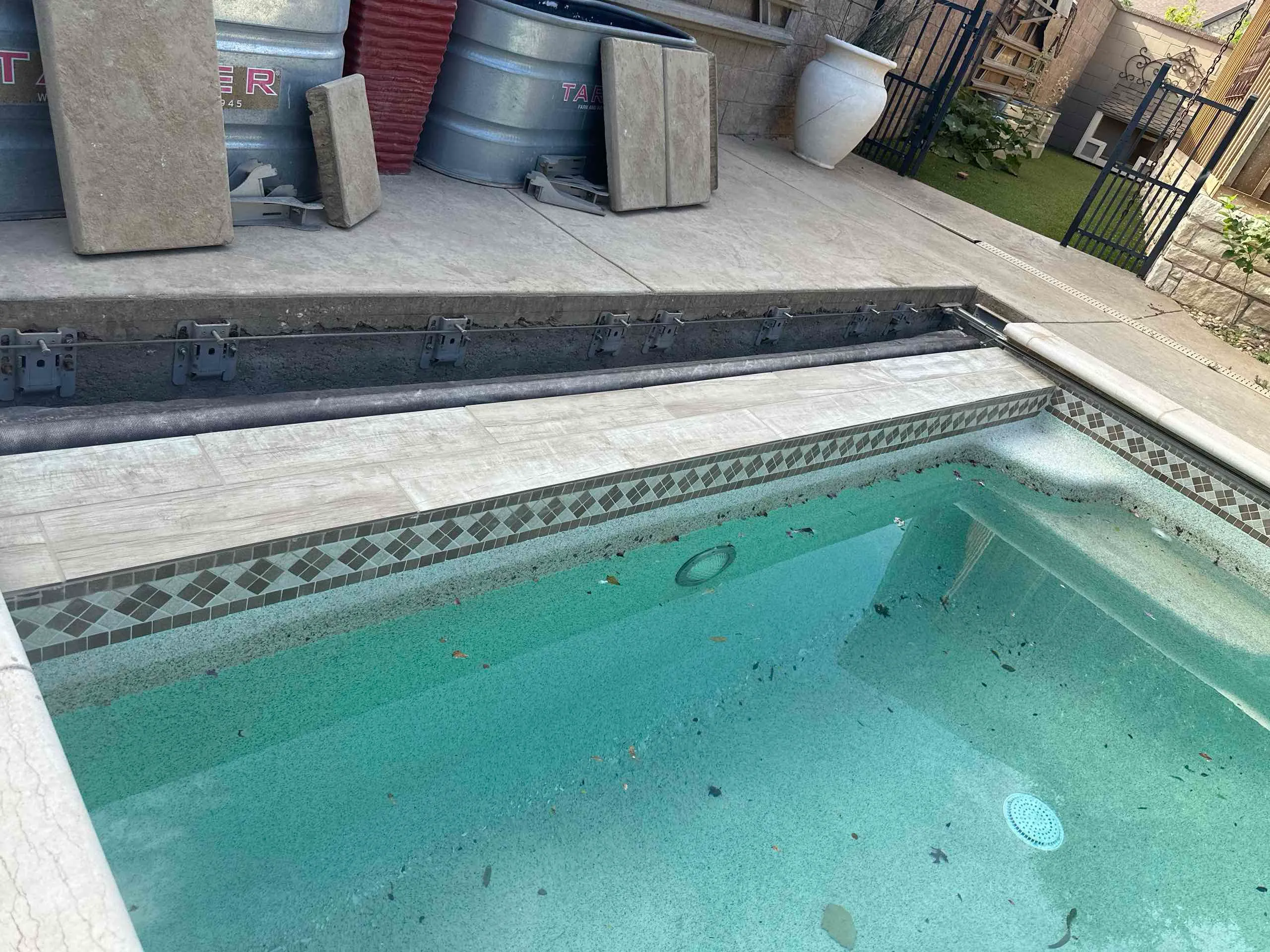 After: Pool edge with tile, coping and pool-cover hardware